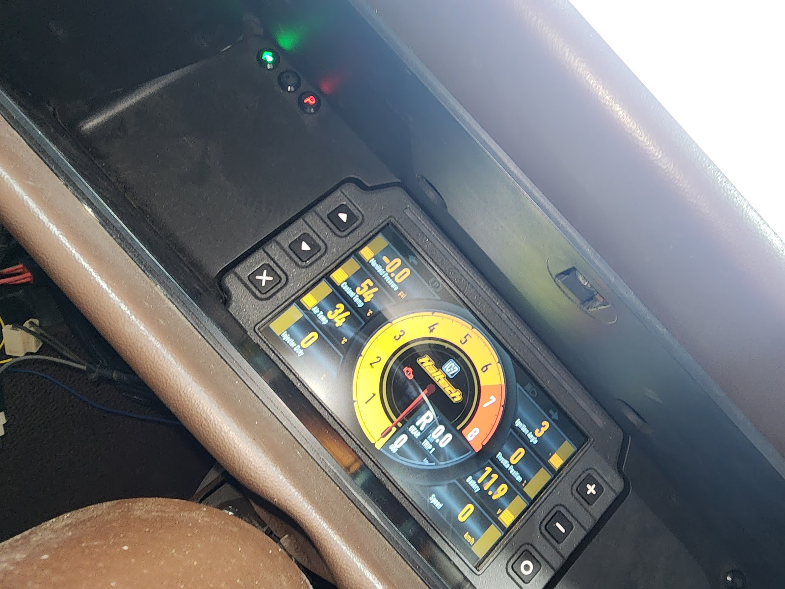 Aftermarket digital dash display lit up inside a car